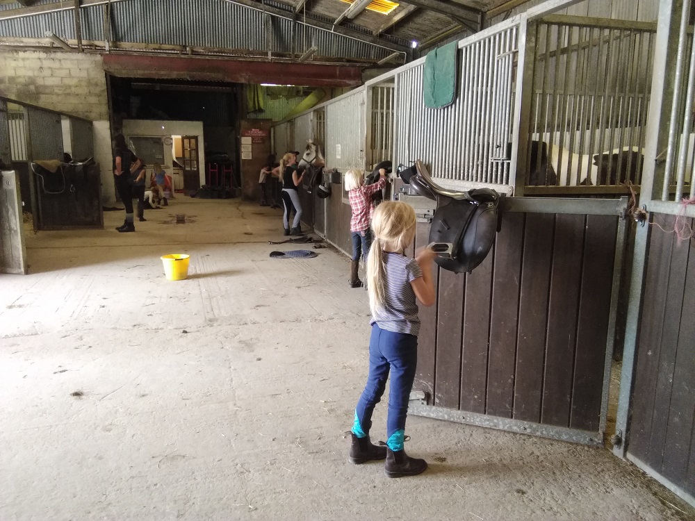 Bryngwyn BHS challenge award girls cleaning horse saddles